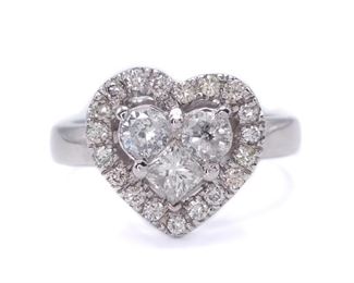 3 Diamonds compose the center heart of this amazingly romantic ring. An outside halo of diamonds accompany the center grouping of diamonds and 14k white gold hugs them all together. The cluster gives a 5.00 carat diamond look! This ring also matches earrings that are being offered in this auction.