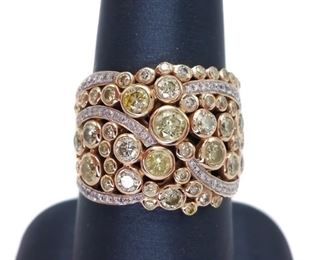 Fancy designer style, this ring will bring a big smile to your face with bezel set natural lemon Yellow Diamonds swirled with white Diamonds in glowing 14k Yellow Gold.