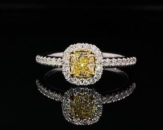 Brand new, never worn! This fantastic ring highlights a VERY coveted 0.50 cushion cut Sweet Pea Yellow Diamond (GIA Report) surrounded by a halo of sparkling white diamonds. 18k yellow gold prongs and cup hold the center stone while white gold finish off the setting by holding all the white diamonds. An exquisite display of color in diamonds and gold.