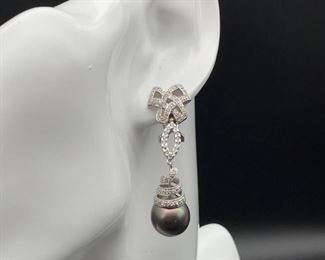 Every lady needs a set of pearls and WOW!! does this auction feature a spectacular set of Tahitian Pearls earrings that have high luster and sheen. Not to mention these pearls are 12-13 mm. The earrings also have 18k White Gold bows, ovals, and spiral s connecting to each large pearl that is covered with 1+ ctw of Diamonds...... because of course, diamonds are a woman's best friend and every lady needs a set of pearls. The set is shown in photos 2 and three, in this lot you are bidding solely on the earrings.