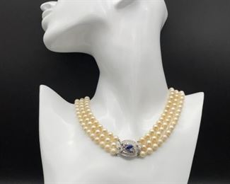 Antique elegance at its finest! 3 strings of truly high luster Ivory Pearls in a 16" long necklace. At 6mm, they are perfectly sized, synchronous, and fitted with a fancy classy clasp: a pear shaped natural Blue Sapphire is at the center of the massive clasp and is surrounded by .28 carats of old cut Diamonds.