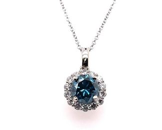 This Fancy Blue Diamond is 1+ ctw. and is surrounded by 0.40 ctw. of VS Clear Diamonds in this 14k White Gold pendant and necklace. 16" 14k white gold chain is included.