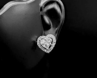 3 Diamonds compose the center heart of these amazingly romantic earrings. An outside halo of diamonds accompany the center grouping of diamonds and 14k White Gold hugs them all together. The cluster gives each earring a 5.00 carat diamond look!