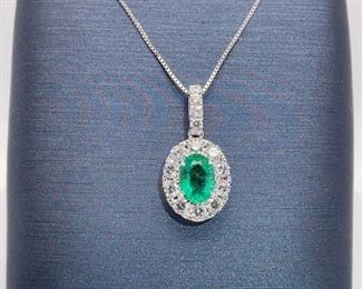Brand New, never worn!! Brilliant green oval natural Emerald is surrounded by a halo of fine Diamonds in an 18k white gold pendant. Chain not included.