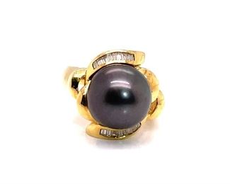 Velvet and Silky massive South Sea Tahitian Black Pearl is center to this flowery diamond and 18k Yellow Gold ring composition. Every other "petal" is loaded with beautiful diamond baguettes to complete this surf and turf style. Would look very nice with the pendant in Lot 34...just saying.