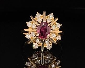 A mesmerizing red Spinel is at the center of this midcentury modern style ring. A 14k yellow golden starburst and halo with intermittent sparling diamonds complete this modern revival on midcentury style. A hot look for any season.