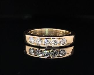 This ring is an example of not needing to mess with a style that is classic and classy. With .80 carats of VS diamonds in a channel set band, this 14k yellow gold ring with exceptional goods is a ring not to miss out on.