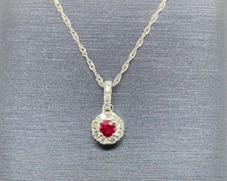 Brand new, never worn! Natural rose red Ruby is set in the middle of spectacular diamonds (VS / F-G) in a halo with 14k white gold is at the heart of this pendant. The chain is included which completes this amazing ensemble.