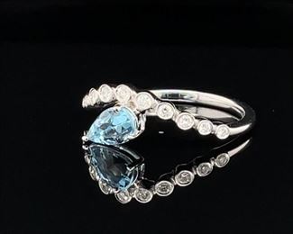 Brand New! Refreshing Natural Pear cut Aquamarine tucked under a wave of Bezel set VS diamonds. A beautiful styled never worn ring set in 14k white gold with a wonderful feeling of tranquility.