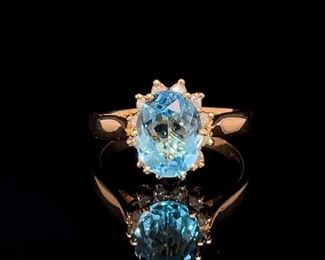A 1.84 carat Ice Blue Topaz pops out of Diamonds in this classic and romantic 14k Yellow Gold Ring.