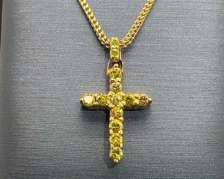 .75 carats of yellow treated natural diamonds make up this classic cross design in 10k yellow gold. Chain measures 22".