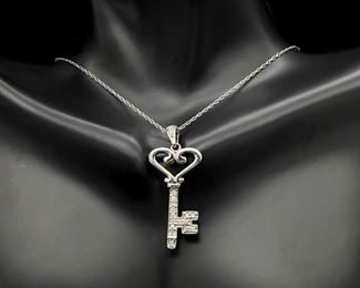Known Designer Styled Diamond Encrusted Heart Shaped Key Necklace in White Gold.