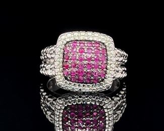 A wonderful fuchsia square of Rubies inside an elegant braided band of sterling silver. There is a total of 1.00 carats of natural Rubies in this wonderful statement ring.