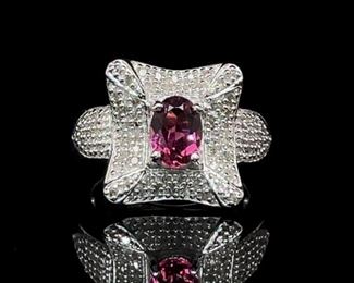 Lilac Pink Oval Cut Tourmaline in the center of a square entourage of Diamonds in sterling silver.