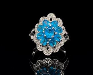 Electric Blue gems glow under a blanket of white gems and are set on a split shank sterling silver band. A bright and happy colored ring to help anyone smile through out the day.