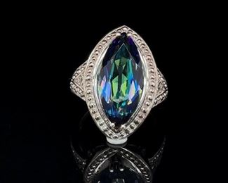 There is something about this Mystic Quartz center gemstone that makes this ring very hard to turn your eyes away. It may be the iridescence or metallic feature of a marquise cut Mystic Quartz against the sterling silver setting. It is, however, one of a kind.