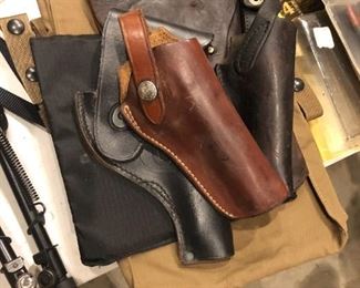 MANY HOLSTERS OF DIFFERENT MATERIALS AND SIZES
