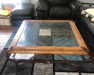 Glass top coffee table with metal and leather base. $200