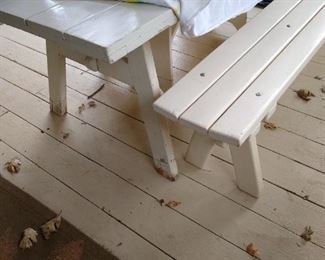 White wooden picnic table and benches.