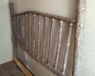 Rustic log headboard.