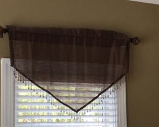 Multiple curtains, window treatments and table cloths.