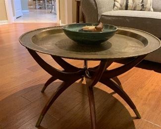 Coppert topped coffee table with wood spider leg base