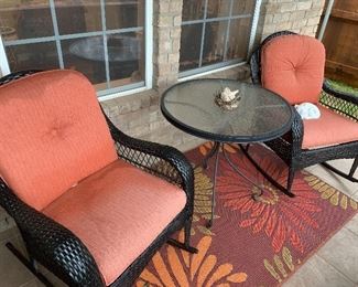 Outdoor wicker style rockers with side table and outdoor rug