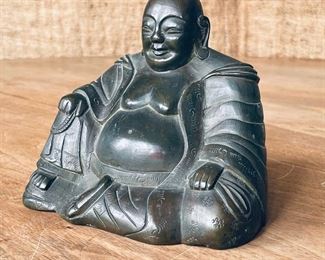 BRONZE BUDDHA FIGURE | seated and wearing a robe, one hand resting on his knee and clutching a strand of beads; h. 4-1/4 x 5-1/4 in. 