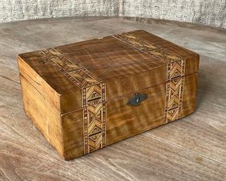 COLORFUL INLAID WOODEN BOX | probably 19th century, with two bands of geometric patterns inlaid in contrasting colorful wood; h.4-1/2 x 10 x 6-1/2 in. 