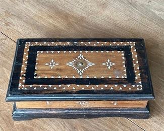 CHINESE COIN, MOTHER-OF-PEARL INLAID BOX | inlaid with mother of pearl, contrasting stain pattern, central Chinese coin; 4 x 13 x 7-3/4 in. 