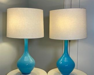PAIR WEST ELM LAMPS | blown transluscent blue glass mounted on round marble bases; h. 33 x dia. 17 in (shade), diameter of lamp only approx. 9 in. 