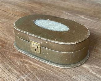 CARVED JADE & LEATHER JEWELRY BOX | the top with a central carved oval jade plaque, in a green leather oval box with gilt decorations, fitted velvet interior, bonus costume necklace!; h.3 x 9 x 5-1/2 in. 