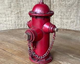 FIRE HYDRANT STILL BANK | 20th century, red painted tin; h. 10 in. 