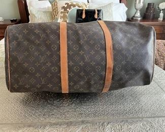 Louis Vuitton duffel bag	22in. X 10.5in x 12in