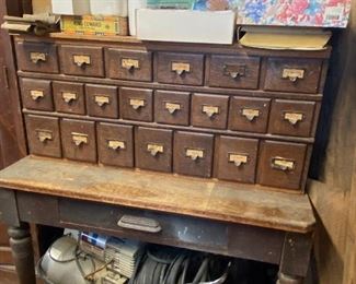 Card catalog cabinet and rustic wooden table/desk.