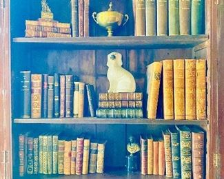 Antique leather books, bronze bust, Staffordshire dog