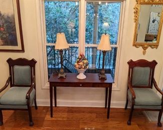 Pair of freshly upholstered mahogany armchairs, single-drawer mahogany sofa table, pair of candlestick lamps and vintage Italian hand-painted Italian porcelain topiary. 