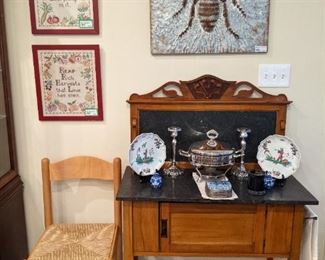 One of a pair of hand embroidered/framed samplers, antique fruitwood dry sink, with hand-carved details and black marble top/backsplash and fun tin bee sign.