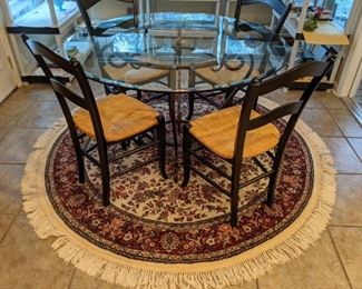 Hand-woven wool rug, with cast iron and beveled glass breakfast table, with set of four side chairs.