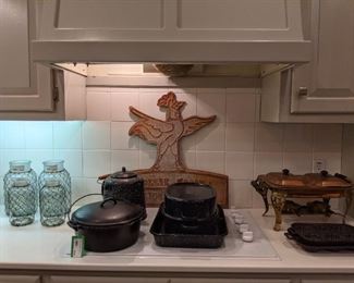 Cast iron cookware, chicken wire glass bottles, splatterware, copper double chafing dish, vintage tin sign.