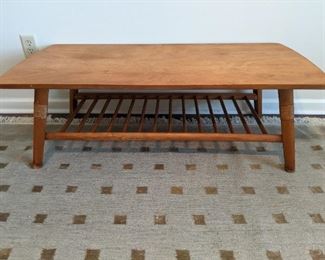 Ah, ANOTHER wonderful blond bombshell from the iconic MCM period, coffee table featuring magazine rack bottom and cane-wrapped table legs!