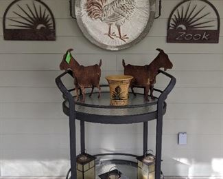 All the right things! A portable wrought iron/glass rolling  bar table, pair of mated rusty ol' goats, vintage "Zook" perfect rusty patina metal signs, morning rooster to gently serenade your every morning.