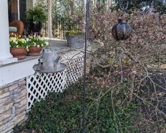 Shepherd's hook with tin teapot birdhouse and solar light.