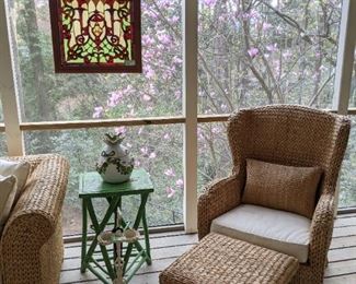Wonderful rattan wingback chair, from Pottery Barn, with matching ottoman, vintage green painted wood folk art side table, antique white painted cast iron smoking stand, stained glass hanging panel and Italian ceramic 2-piece pineapple, with green apple garland. 