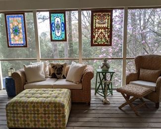 Custom made polka dot ottoman, that opens to reveal a pop-up writing desk, rattan love seat, from Pottery Barn, Belgian tapestry bulldog pillow, with down insert and triptych of stained glass hanging panels. 