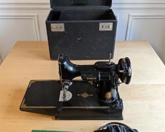 Vintage Singer "Featherweight 221" sewing machine, with tools and carrying case; 1933 - 1961.