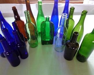 glass bottles, some vintage, some with holes for string of lights