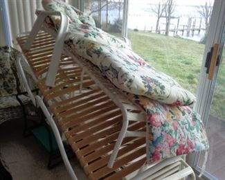 several chaise lounge chairs and cushions