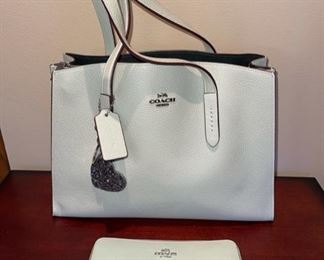 Very nice selection of newer Coach handbags and wallets, including this “Charlie Carryall” Pebble Leather model in Sky Silver
