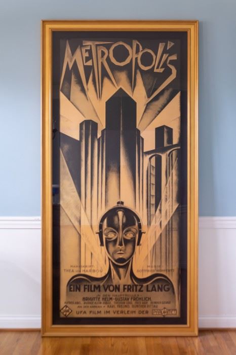 Metropolis 1927 Fritz Lang 3 Sheet Movie Poster Lithograph S2.  Professionally framed artwork under mat board is larger than what is visible. Visible artwork measures 35 ⅝" x 82 3/16".  Frame measures  46"  x 92 1/4". This Metropolis 3-sheet is a hand pulled lithograph of the original movie poster featuring image of False Maria.